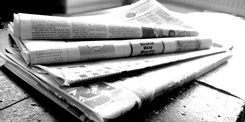 Photo of a stack of newspapers.