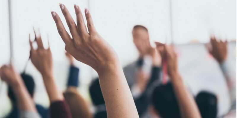 Image of people raising their hands.