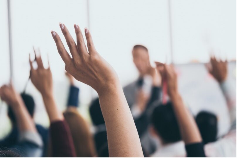 Image of people raising their hands.