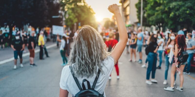 Image of a young person with a raised fist.