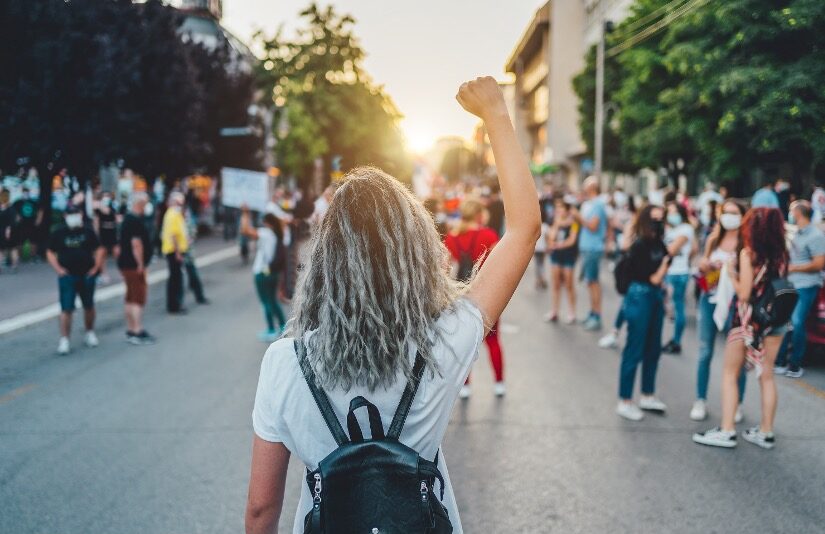 Image of a young person with a raised fist.